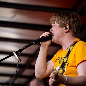man playing a guitar and singing